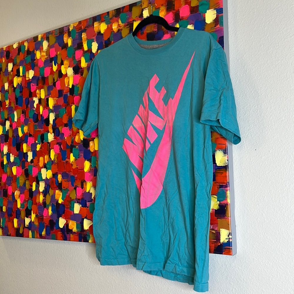 Blue shirt with pink Nike logo